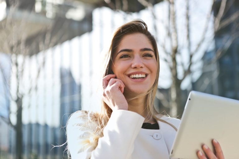 woman-in-white-blazer-holding-tablet-computer-789822-768x512