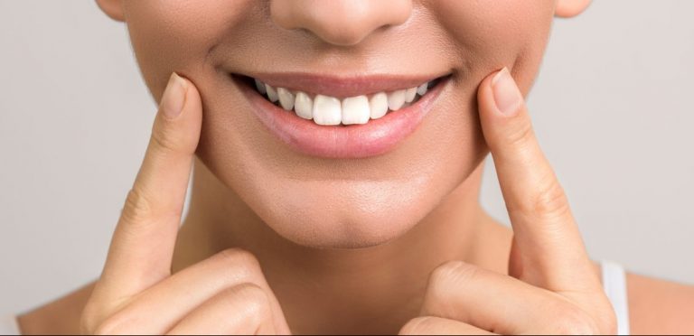 closeup view of female wide cheerful smile with white teeth and clean skin and copyspace