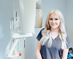 Practice manager Jenny Jones stood next to intraoral scanner at Marquess Dental