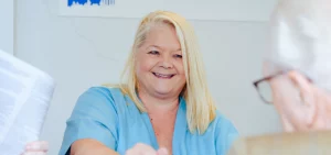 Pam the dental nurse chatting with a patient about dental plans